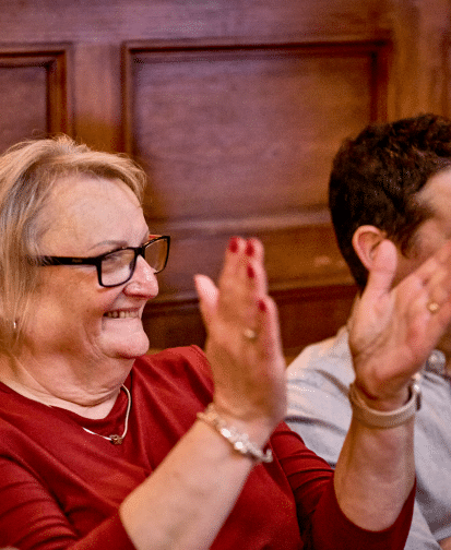 A woman clapping and smiling